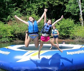 Jumping off trampoline into Leesville Lake at our overnight summer camp.